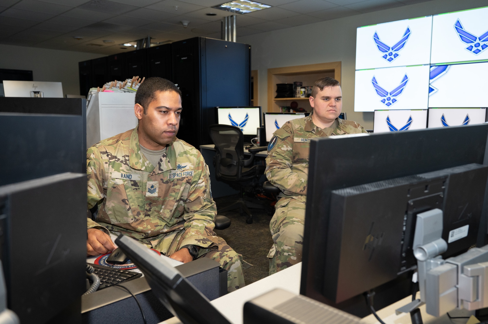 Guardians work at their computers in the Systems Center.
