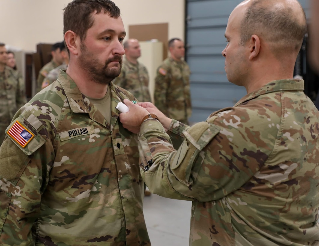 Col. Steven Engels, 75th Troop Command, pins Spc. Brandon Pollard with an Army Commendation Medal following his heroic actions following an accident in Shelby County, March 15, 2025. Pollard helped a driver from her overturned vehicle following a weather-related crash. (U.S. Army National Guard courtesy asset)