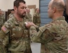 Col. Steven Engels, 75th Troop Command, pins Spc. Brandon Pollard with an Army Commendation Medal following his heroic actions following an accident in Shelby County, March 15, 2025. Pollard helped a driver from her overturned vehicle following a weather-related crash. (U.S. Army National Guard courtesy asset)