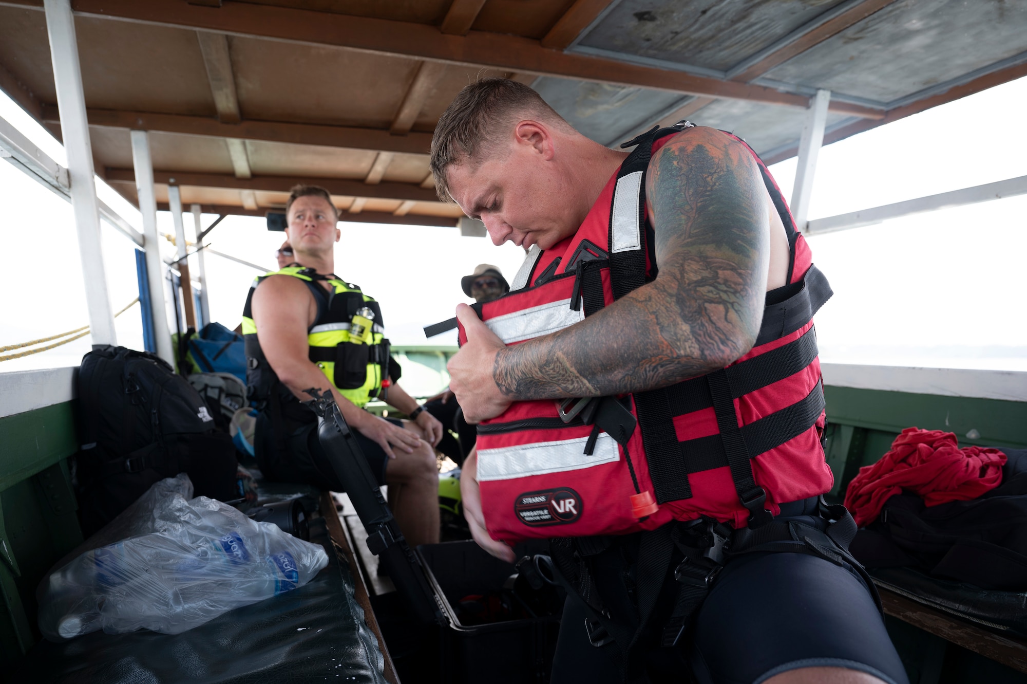 U.S. Army Staff Sgt. James Fernald, left, and 1st Sgt. Peter Knope, United States Army Air Ambulance Detachment (USAAAD), 1st Battalion, 228th Aviation Regiment Joint Task Force-Bravo critical care flight paramedics, prepare for a simulated overwater hoist rescue at Lake Yojoa, Honduras, April 22, 2025. During the two-day event, several HH-60L Black Hawk pilots practiced multiple over water hoist operations utilizing different extraction devices (U.S. Air Force photo by Staff Sgt. Sadie Colbert)