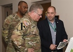 Man shows document to another man