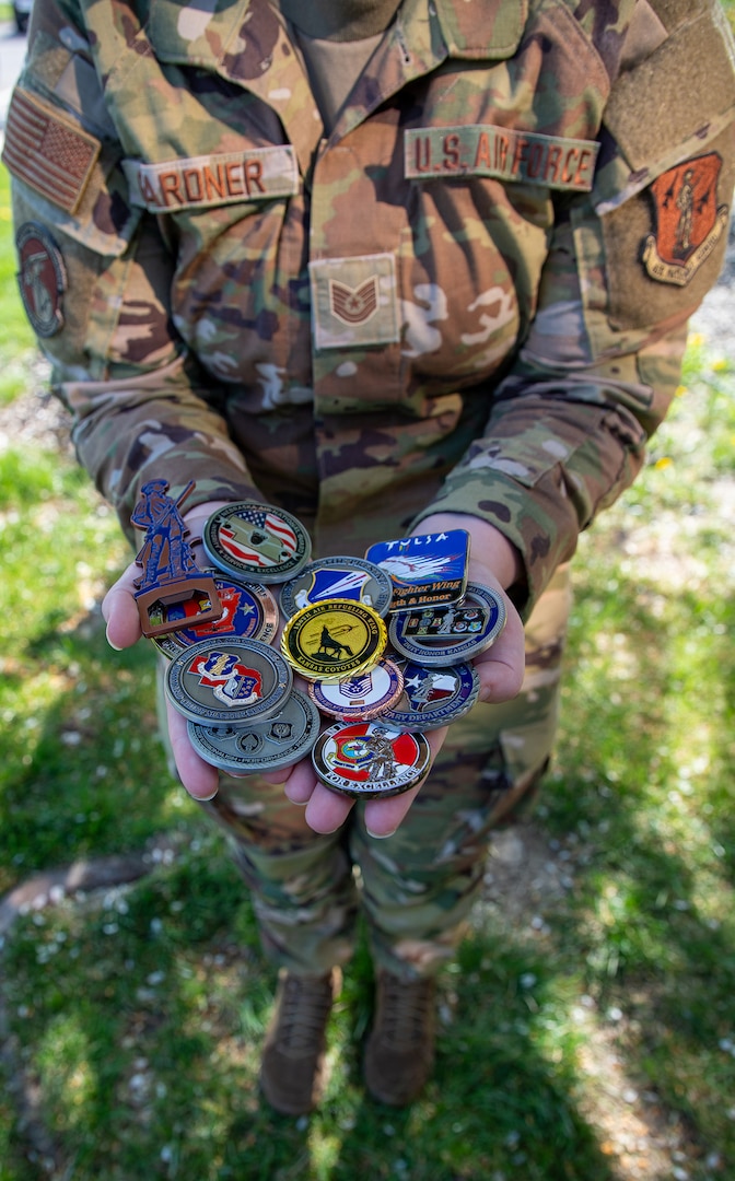 U.S. Air National Guard Technical Sgt. Jamie Gardner, 190th Air Refueling Wing, receives a collection of military challenge coins at Rosecrans Air National Guard Base, Missouri, April 16, 2025.