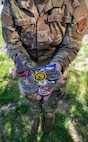 U.S. Air National Guard Technical Sgt. Jamie Gardner, 190th Air Refueling Wing, receives a collection of military challenge coins at Rosecrans Air National Guard Base, Missouri, April 16, 2025.