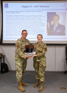 U.S. Air National Guard Technical Sgt. Jamie Gardner, 190th Air Refueling Wing,  poses with a plaque at Rosecrans Air National Guard Base, Missouri, April 16, 2025.