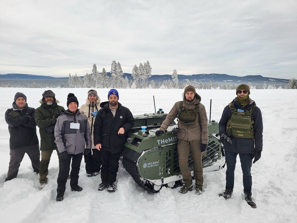CRREL team members along with OUSD and Milrem Robotics staff with the company’s THeMIS UGV. According to Milrem Robotics, the THeMIS is a modular, unmanned platform designed for various applications, including logistics, reconnaissance, medical evacuations and operational support. Photo by Mike Parker, CRREL.