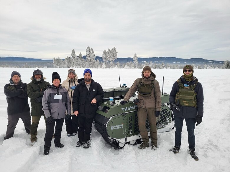CRREL team members along with OUSD and Milrem Robotics staff with the company’s THeMIS UGV. According to Milrem Robotics, the THeMIS is a modular, unmanned platform designed for various applications, including logistics, reconnaissance, medical evacuations and operational support. Photo by Mike Parker, CRREL.