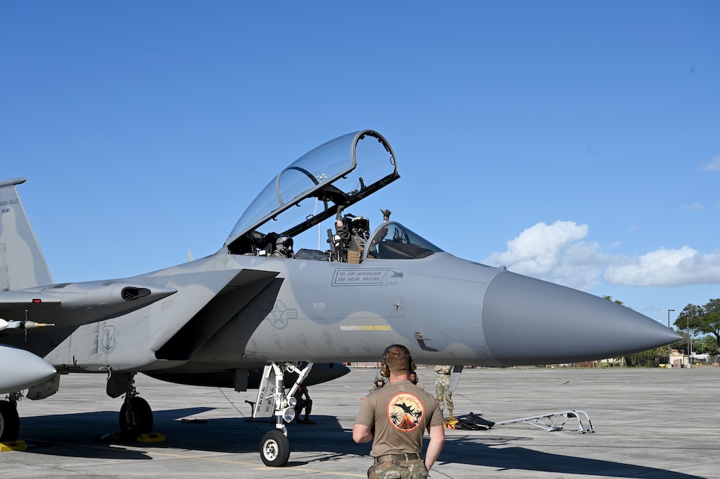 Crew chiefs talk to a pilot before taxiing