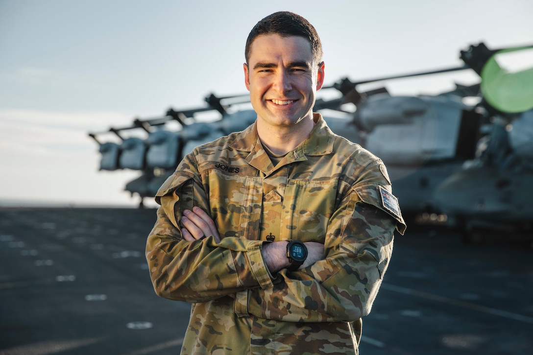 Australian Army Maj. Jack Jones, the assistant logistics officer of the 15th Marine Expeditionary Unit, poses for a photo aboard the amphibious assault ship USS Boxer (LHD 4) while underway in the Pacific Ocean Nov. 21, 2024. Jones recently deployed with the 15th MEU to the Indo-Pacific region as part of the Marine Corps Personnel Exchange Program. (U.S. Marine Corps photo by Cpl. Luis Agostini)