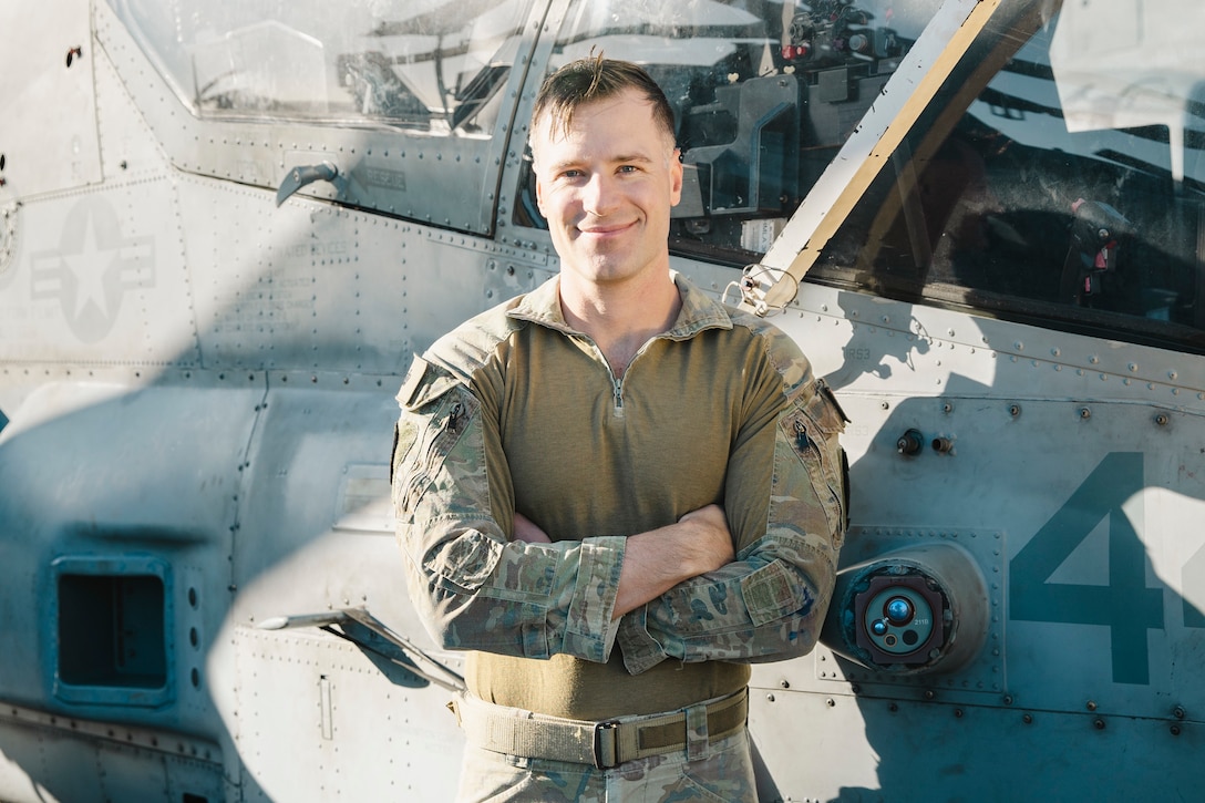 Australian Army Maj. Rhys Davies, an AH-1Z Viper pilot assigned to Marine Medium Tiltrotor Squadron (VMM) 165 (Reinforced), 15th Marine Expeditionary Unit, poses for a photo aboard the amphibious assault ship USS Boxer (LHD 4) while underway in the Pacific Ocean Nov. 21, 2024. Davies recently deployed as part of the 15th MEU’s aviation combat element through the Marine Corps Personnel Exchange Program. In the Australian Army, Davies flew the Tiger Armed Reconnaissance helicopter with 16th Aviation Brigade, 1st Aviation Regiment, and learned to pilot the AH-1Z Viper aircraft upon attaching to VMM-165 (Rein.). (U.S. Marine Corps photo by Cpl. Luis Agostini)