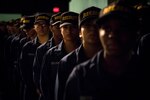 150605-N-AT895-113 GREAT LAKES, Ill.  (June 5, 2015) Recruits at Recruit Training Command (RTC) at Naval Station Great Lakes prepare to receive their Navy ball caps after completing Battle Stations, the final exercise before graduation. (U.S. Navy photo by Mass Communication Specialist 1st Class Nathan Laird/Released)