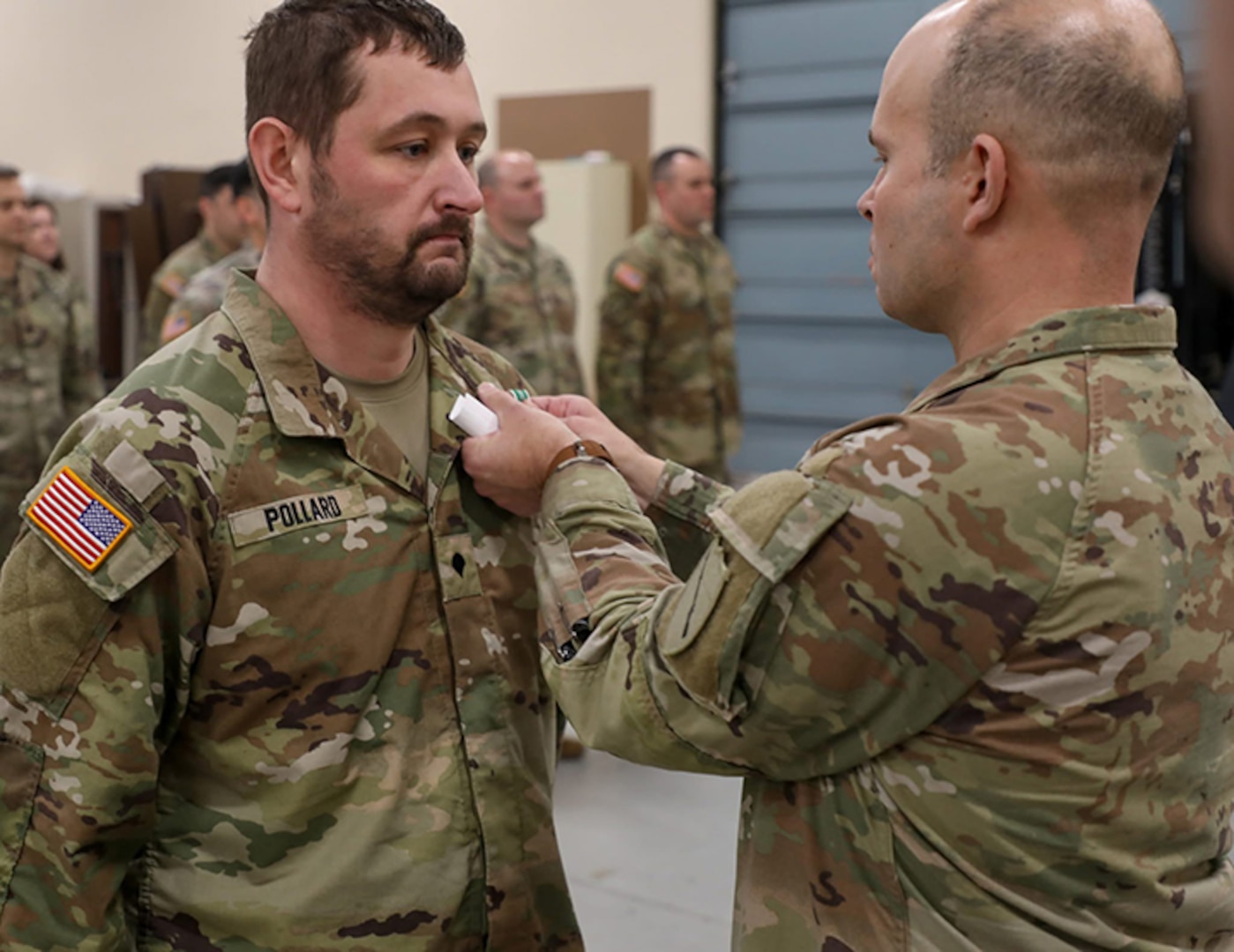 Col. Steven Engels, 75th Troop Command, pins Spc. Brandon Pollard with an Army Commendation Medal following his heroic actions following an accident in Shelby County, March 15, 2025.