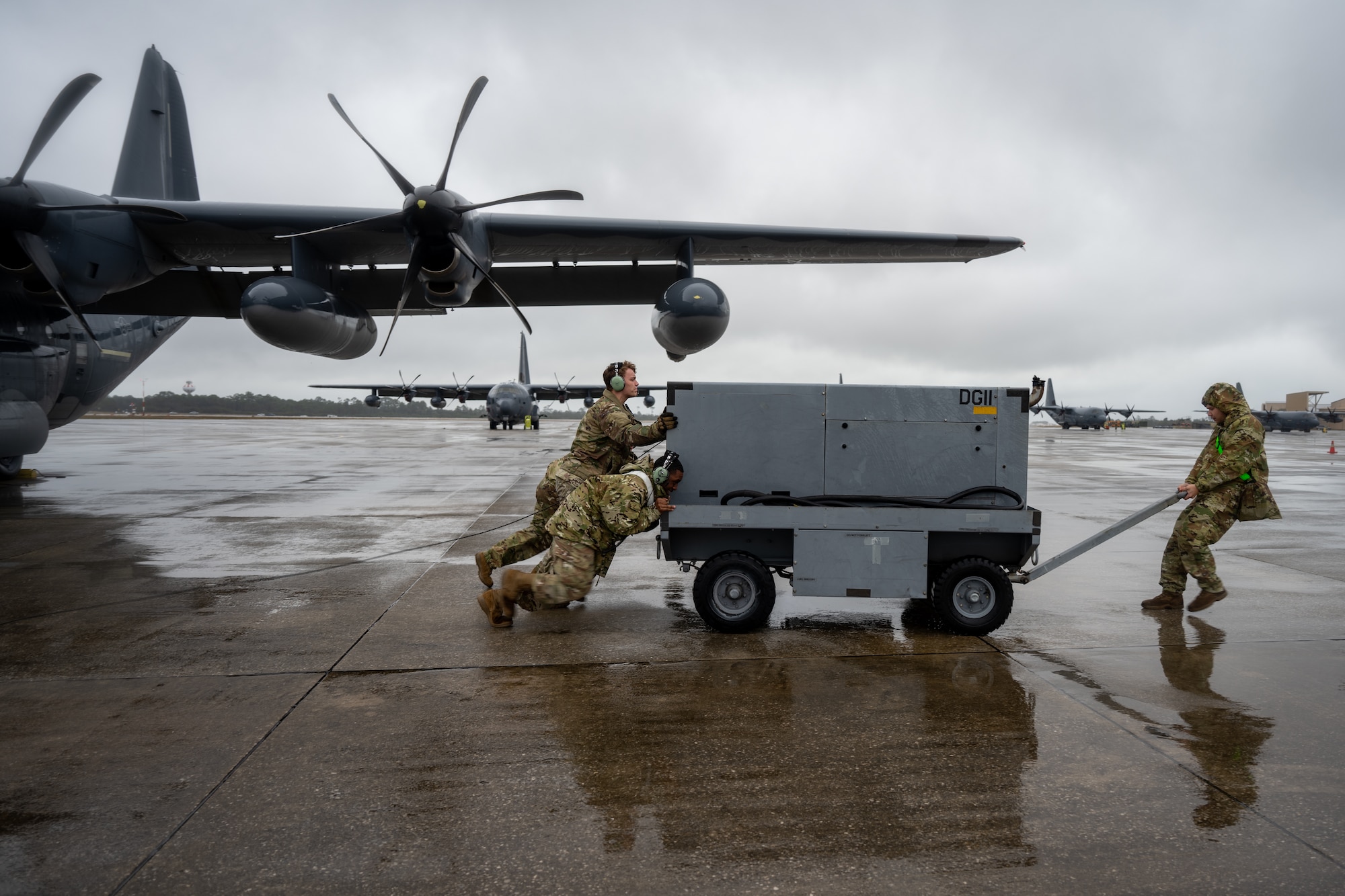 U.S. Airmen push an external power generator at Hurlburt Field, Florida, Feb. 19, 2025.