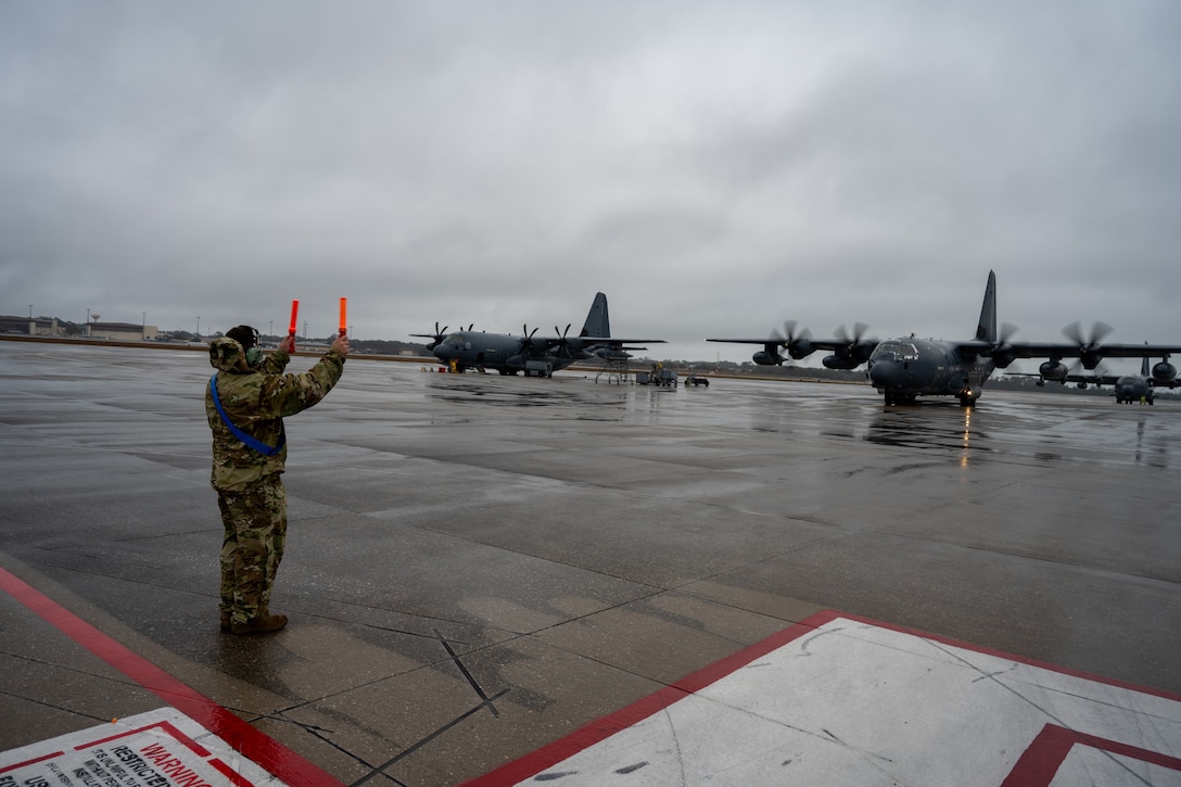 A U.S. Air Force crew chief assigned to the 1st Special Operations Wing marshals a crew aboard an MC-130J Commando II to the runway at Hurlburt Field, Florida, Feb. 19, 2025. Maintainers at the 1 SOW perform a myriad of tasks around the clock, maintaining and inspecting aircraft, assisting crews during launch and handling quick turn missions. (U.S. Air Force photo by Senior Airman Hussein Enaya)