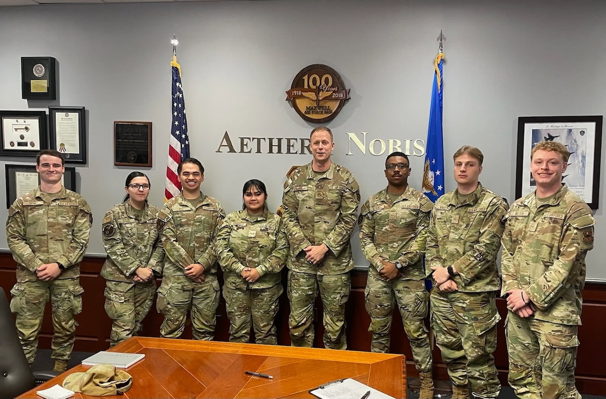 U.S. Airmen from the Maxwell-Gunter dorm council and Chief Master Sgt. Caleb Vaden, middle, pose for a photo at a dorm council meeting at Maxwell Air Force Base, Alabama, April 8, 2025.