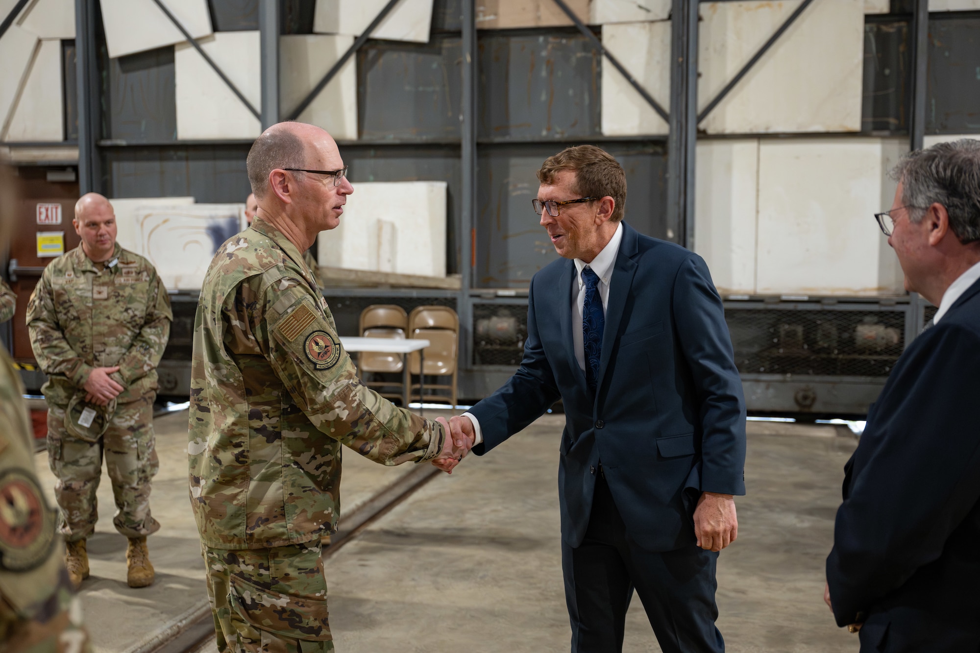 Gen. Duke Z. Richardson, commander of Air Force Materiel Command, left, shakes hands with Joshua Johns, Arnold Engineering Development Complex Financial Management technical director, during an April 24, 2025, visit to Arnold Air Force Base, Tenn. Richardson visited Arnold AFB, headquarters of AEDC, to tour several test facilities, meet with personnel, and receive updates on various programs and projects. (U.S. Air Force photo by Keith Thornburgh)