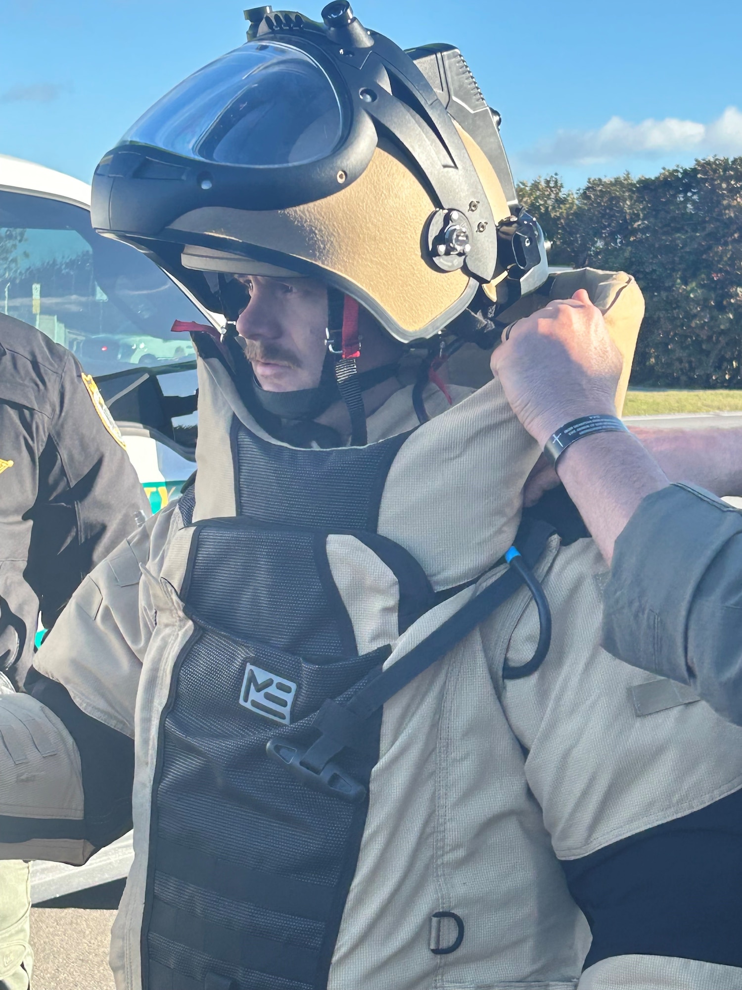 An Airman puts on a bomb suit.