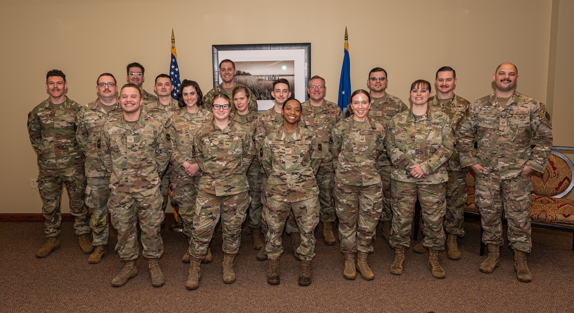 a group of military member pose for a photo