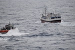A Coast Guard Cutter Calhoun (WMSL 759) small boat approaches a vessel suspected of drug smuggling in the Atlantic Ocean, April 12, 2025. Calhoun crew members boarded the fishing vessel approximately 1,265 miles west of Las Palmas, Canary Islands, seizing approximately 10,000 pounds of cocaine worth an estimated $74 million. (U.S. Coast Guard photo)