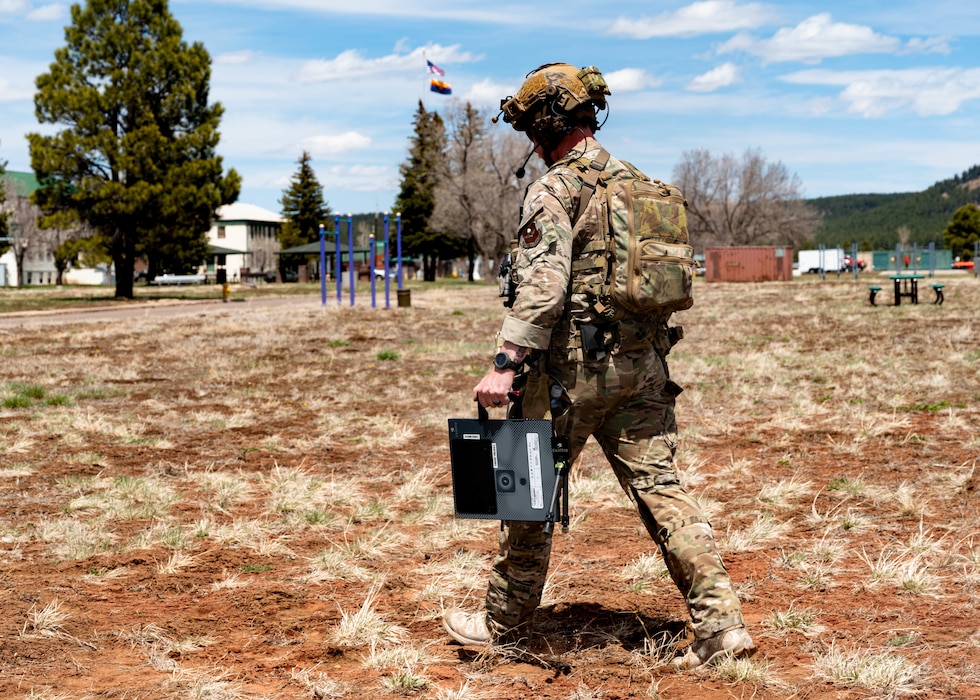 U.S. Air Force Senior Airman Kevin Hodgson, 56th Civil Engineer Squadron explosive ordnance disposal technician, carries a new X-ray system during a field exercise.