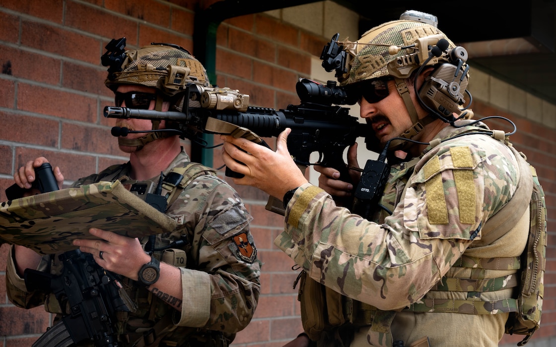 U.S. Air Force Senior Airmen Zachary Vincent (right) and Kevin Hodgson (left), 56th Civil Engineer Squadron explosive ordnance disposal technicians, survey the location of the explosive hazards during a field exercise.