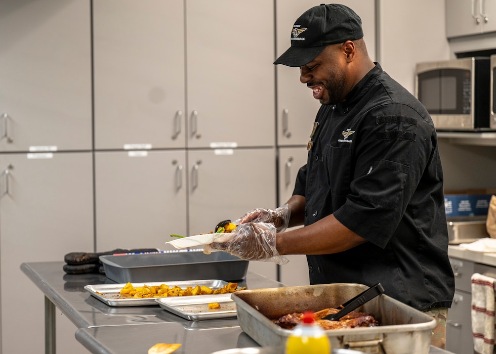 U.S. Air Force Staff Sgt. Larry Covington, 56th Force Support Squadron catering craftsman, plates food during a dorm cooking class