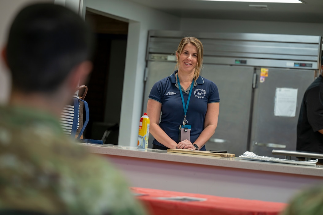 Kristen David, 56th Medical Group health promotion dietitian, briefs Airmen on the importance of nutrition during a dorm cooking class