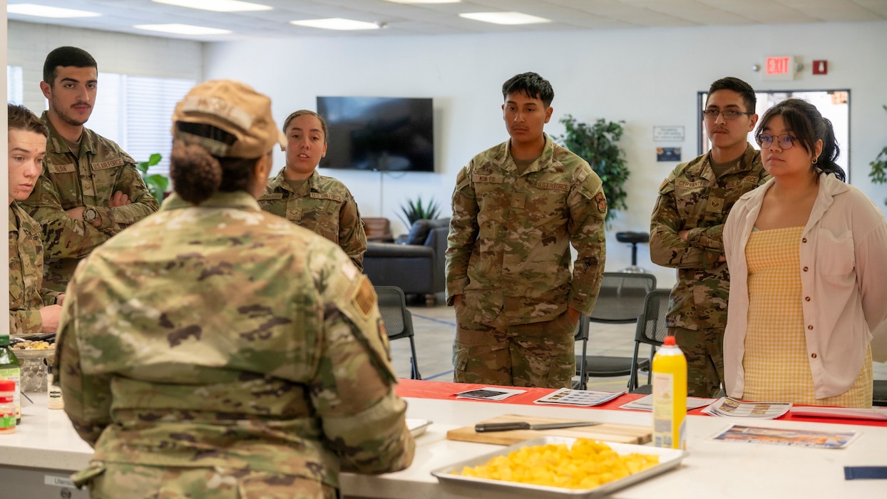 U.S. Air Force Senior Airman Kaitlyn Moore, 56th Force Support Squadron resource advisor assistant, briefs Airmen on the importance of kitchen safety during a dorm cooking class.