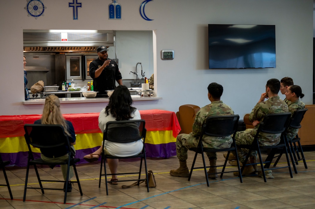 U.S. Air Force Staff Sgt. Larry Covington (center), 56th Force Support Squadron catering craftsman, answers a question about food safety protocols during a dorm cooking class