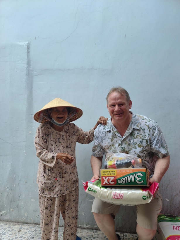 Photo of Security and Law Enforcement Chief John Landers taking care of the poor while on vacation in Vietnam. Landers and his wife make it a practice to buy vital supplies and distribute among residents in local villages. (Courtesy John Landers)