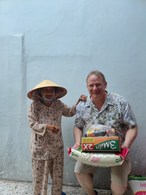 Photo of Security and Law Enforcement Chief John Landers taking care of the poor while on vacation in Vietnam. Landers and his wife make it a practice to buy vital supplies and distribute among residents in local villages. (Courtesy John Landers)