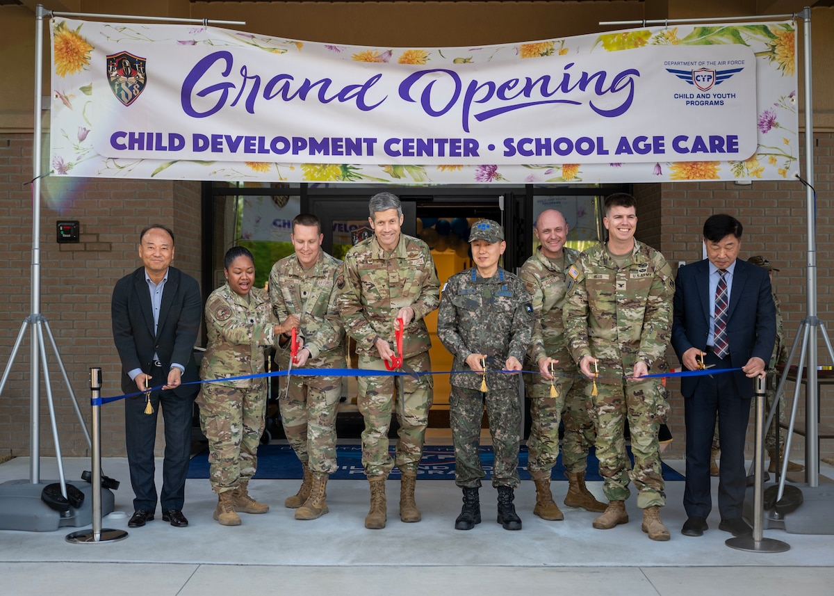 Leadership from the 51st Fighter Wing and Republic of Korea Air Force cut a ribbon during the opening ceremony of the new Child Development Center at Osan Air Base, Republic of Korea, April 24, 2025. The new facility was constructed through a Republic of Korea-funded project under the Special Measures Agreement, with U.S. and Korean partners ensuring it met military family needs and quality standards. (U.S. Air Force photo by Senior Airman Sarah Williams)