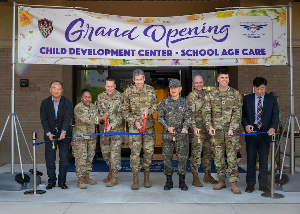 Leadership from the 51st Fighter Wing and Republic of Korea Air Force cut a ribbon during the opening ceremony of the new Child Development Center at Osan Air Base, Republic of Korea, April 24, 2025. The new facility was constructed through a Republic of Korea-funded project under the Special Measures Agreement, with U.S. and Korean partners ensuring it met military family needs and quality standards. (U.S. Air Force photo by Senior Airman Sarah Williams)