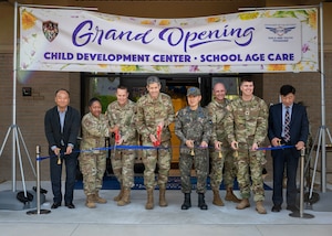 Leadership from the 51st Fighter Wing and Republic of Korea Air Force cut a ribbon during the opening ceremony of the new Child Development Center at Osan Air Base, Republic of Korea, April 24, 2025. The new facility was constructed through a Republic of Korea-funded project under the Special Measures Agreement, with U.S. and Korean partners ensuring it met military family needs and quality standards. (U.S. Air Force photo by Senior Airman Sarah Williams)