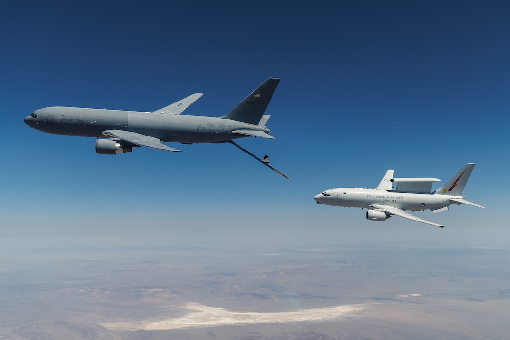 A KC-46A assigned to the 418th Flight Test Squadron at Edwards Air Force Base positions to refuel a Royal Australian Air Force E-7A Wedgetail in the airspace near Edwards. Aircrews from the USAF, RAAF, and Royal Air Force worked together to rapidly certify this enhanced combat capability for the RAAF E-7A fleet. The trilateral test also allowed the United Kingdom and United States Air Force to gain early test experience ahead of their anticipated fielding of E-7 aircraft variants. (Air Force photo by Richard Gonzales)