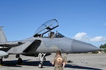A U.S. Air Force F-15 Eagle crew chief from the 173rd Fighter Wing at Kingsley Field assists an F-15 pilot with pre-flight gear checks during exercise Sentry Aloha at Joint Base Pearl Harbor-Hickam, Hawaii, April 15, 2025. Maintenance crews during Sentry Aloha met and exceeded the line standards given during flight operations and took on additional duties which contributed to over 20 successful familiarization flights. (U.S. Air National Guard photo by Master Sgt. Daniel Reed)