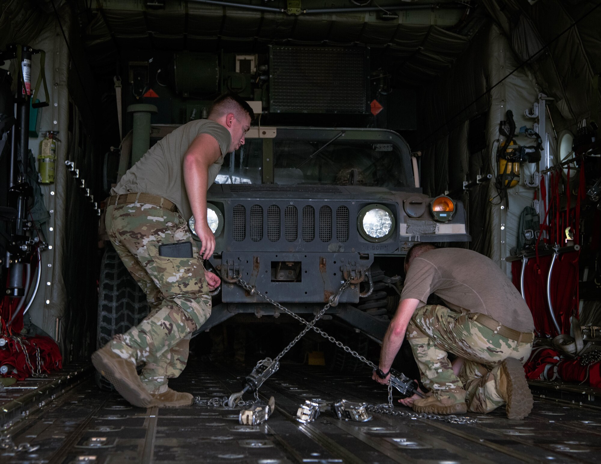 U.S. Air Force Senior Airman Zane Richardson, left, a loadmaster, and Senior Master Sgt. William Murray, right, a senior enlisted leader, both with 39th Airlift Squadron, secure a U.S. Army Humvee assigned to 5th Battalion, 3rd Field Artillery Regiment, 1st Multi Domain Task Force, on a C-130J Super Hercules, during Exercise Balikatan 25 at at Clark Air Base, Philippines, April 23, 2025. Balikatan is a longstanding annual exercise between the Armed Forces of the Philippines and U.S. military designed to strengthen our ironclad alliance, improve our capable combined force, and demonstrate our commitment to regional security and stability. (U.S. Marine Corps photo by Sgt. Mitchell Johnson)