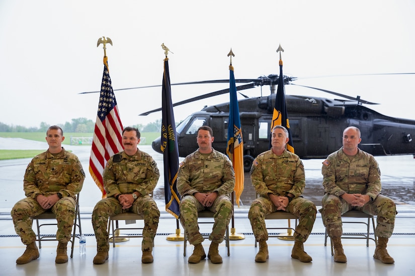 The official party sits in front of families and Soldiers during the deployment ceremony. From left to right are Col. Gabriel Spicer, 63rd TAB brigade commander, Capt. Corey Oney, 2-238th MEDEVAC commander, Command Sgt. Maj. Zachary Downs, 63rd TAB sergeant major, Chief Warrant Officer 5 Kevin Keith, 63rd TAB command chief warrant officer, and Chaplain Eric Honeycutt. Approximately 30 Soldiers from the 2-238th are deploying to Europe in support of intratheater aeromedical evacuations. (U.S. Army National Guard photo by Sgt. First Class Ryan Wilhoit)