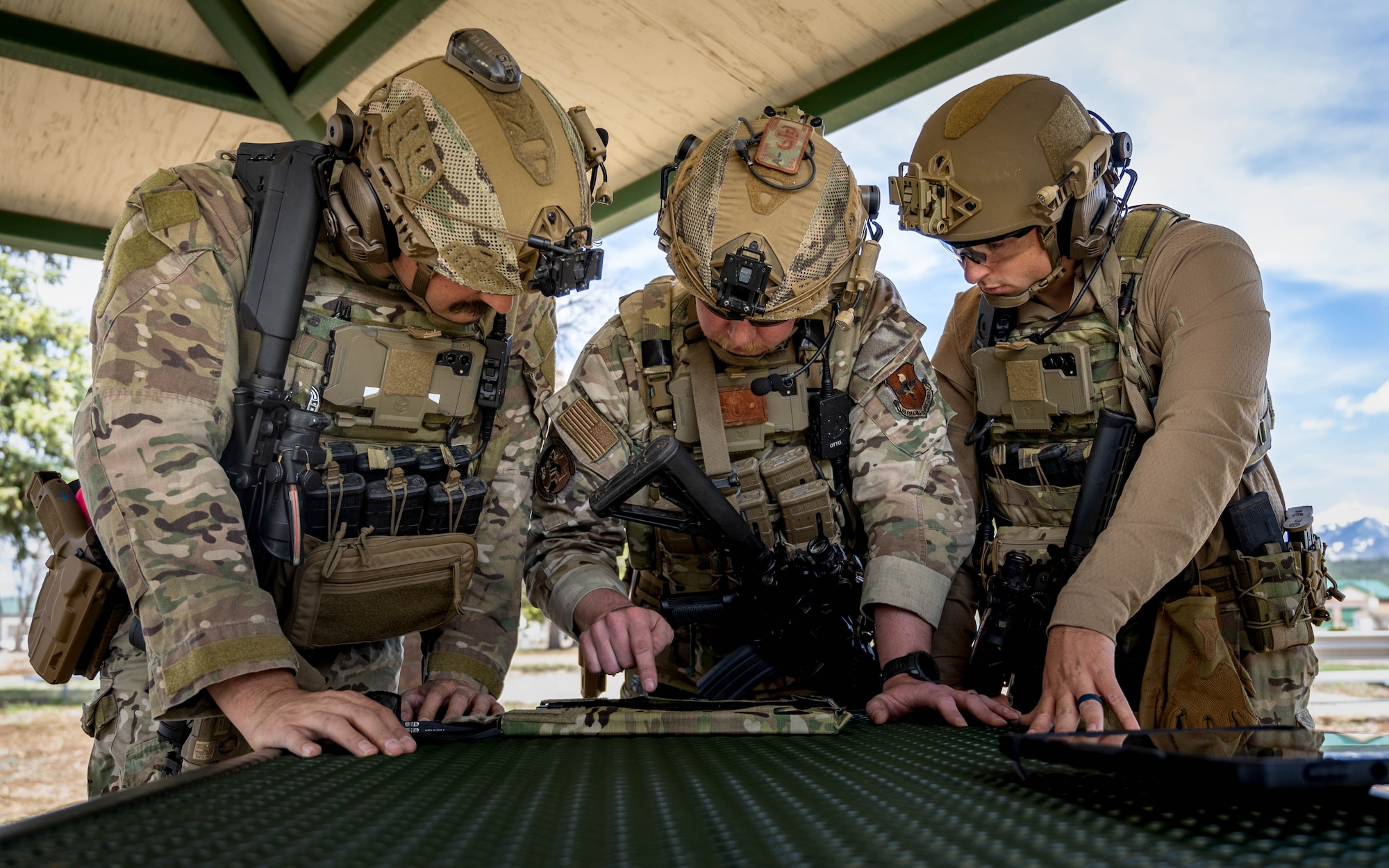 U.S. Air Force Senior Airmen Zachary Vincent (left), Kevin Hodgson (center), Matthew Helms (right), 56th Civil Engineer Squadron explosive ordnance disposal technicians, analyze the readout from an X-ray system during a field exercise.