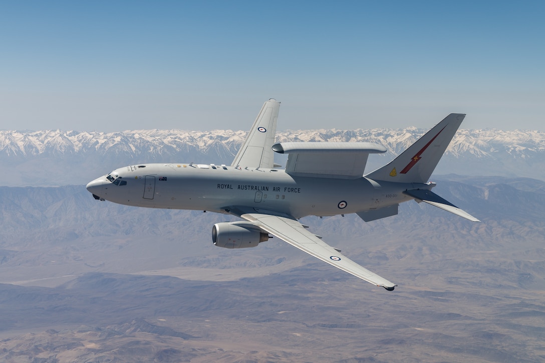 A Royal Australian Air Force E-7A Wedgetail soars over Southern California. Aircrews from the USAF, RAAF, and Royal Air Force worked together to rapidly certify the RAAF E-7A with the United States Air Force KC-46A. The trilateral test also allowed the United Kingdom and United States Air Force to gain early test experience ahead of their anticipated fielding of E-7 aircraft variants. (Air Force photo by Richard Gonzales)