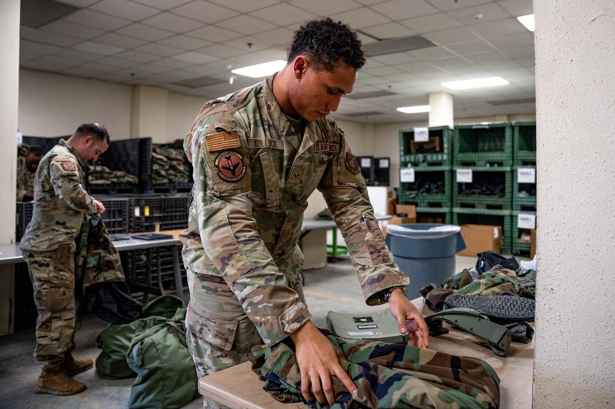 U.S. Air Force Senior Airmen Oliver Kollock, 51st Logistics Readiness Squadron individual protective equipment journeyman, issues IPE to installation members at Osan Air Base, April 16, 2025.