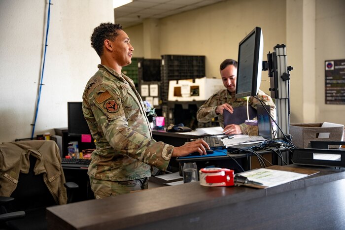U.S. Air Force Senior Airmen Oliver Kollock, 51st Logistics Readiness Squadron individual protective equipment journeyman, left, checks in Airmen in need of IPE at Osan Air Base, April 16, 2025.