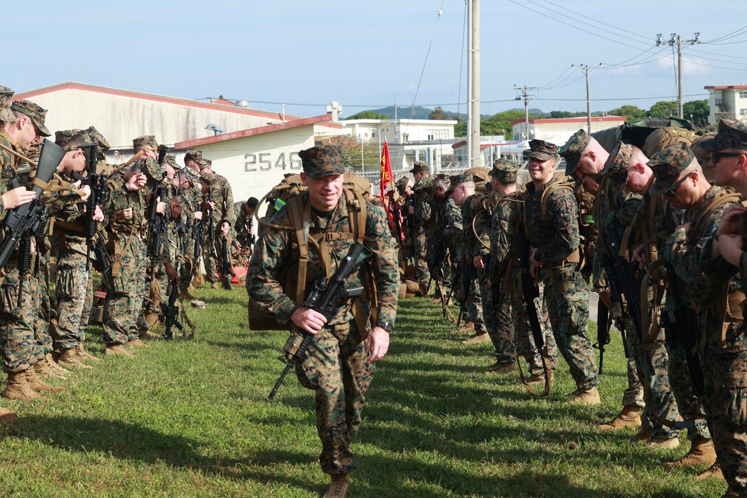CAMP HANSEN, Okinawa, Japan (April 9, 2025) — Brig. Gen. Trevor Hall performs a troop welfare check following the completion of the 3D Marine Expeditionary Brigade’s 10K conditioning hike, ensuring the well-being of the Marines after the rigorous event. The hike enhances physical fitness and prepares the unit for rapid crisis response, disaster relief, and humanitarian assistance across the Indo-Pacific. (U.S. Marine Corps photo by 2nd Lt. Giovanni A. Jimenez)