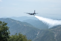 A C-130 (MAFFS 9) from Nevada Air National Guard's 152nd Airlift Wing performs a water drop April 24, 2025, during Modular Airborne Fire Fighting System (MAFFS) Spring Training 2025, hosted by the California Air National Guard's 146th Airlift Wing.