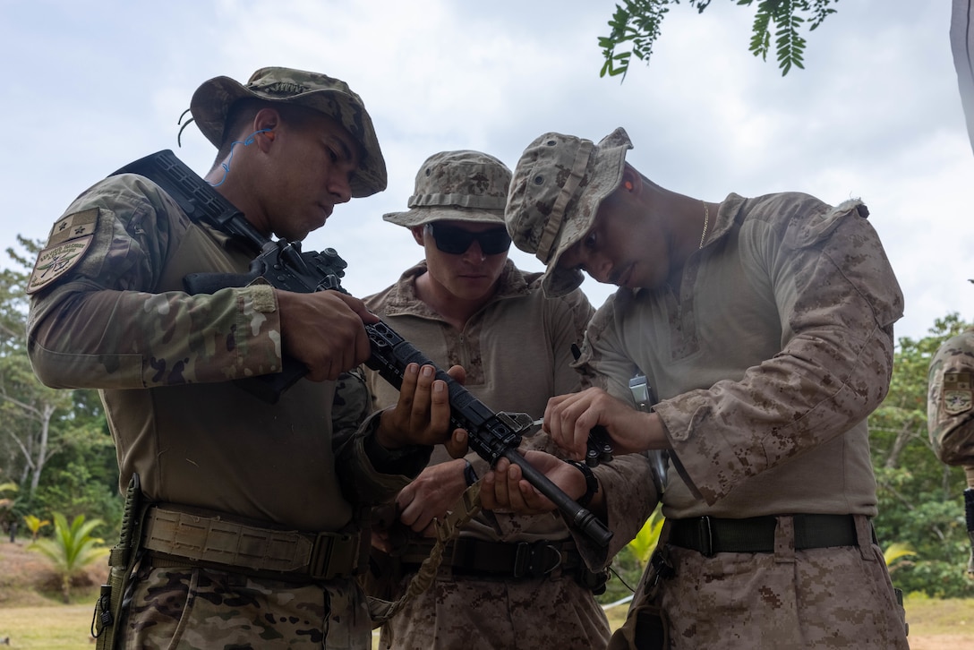 U.S. Marine Corps Lance Cpl. Jesus Reynoso Guzman, a Bronx, New York native and team leader with 1st Battalion, 8th Marines, 6th Regiment, 2d Marine Division adjusts a Panamanian security force member's iron sight in Horoko, Panama, April 19, 2025. U.S. Southern Command is focused on increasing partner nation capacity and interoperability in the region and reflects the United States’ enduring promise of friendship, partnership, and solidarity with the Panamanian people. (U.S. Marine Corps photo by Lance Cpl. Francis Hrosar)