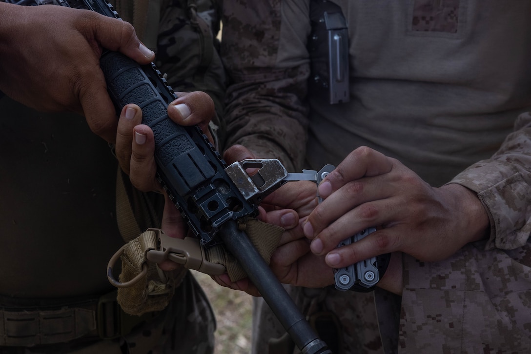 A U.S. Marine with 1st Battalion, 8th Marines, 6th Regiment, 2d Marine Division adjusts a Panamanian security force member's iron sight in Horoko, Panama, April 19, 2025. U.S. Southern Command is focused on increasing partner nation capacity and interoperability in the region and reflects the United States’ enduring promise of friendship, partnership, and solidarity with the Panamanian people. (U.S. Marine Corps photo by Lance Cpl. Francis Hrosar)