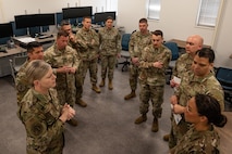 A group of people standing around in a half circle