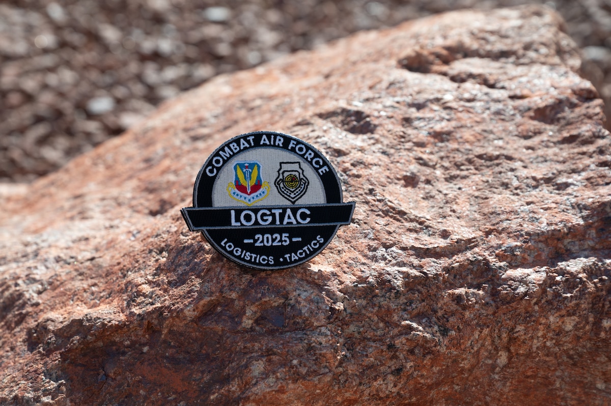 a LOGTAC coin on a rock