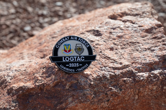 a LOGTAC coin on a rock