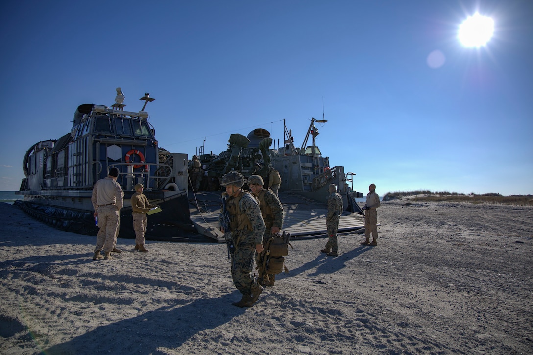 U.S. Marines with the 24th Marine Expeditionary Unit (Special Operations Capable) walk across the beach preparing to head back to base, Onslow Beach, North Carolina, Dec. 2, 2024. The Marines with the 24th MEU (SOC) return to Camp Lejeune following a 7-month long deployment to U.S. Naval Forces Europe and Africa area of operation. Embarked on the Navy’s Wasp Amphibious Ready Group, the 24th MEU (SOC) supported U.S. Allied, and partner interests in the region, including the Eastern Mediterranean Sea, to promote regional stability and deter aggression. (U.S. Marine Corps photo by Sgt. Michele Clarke)