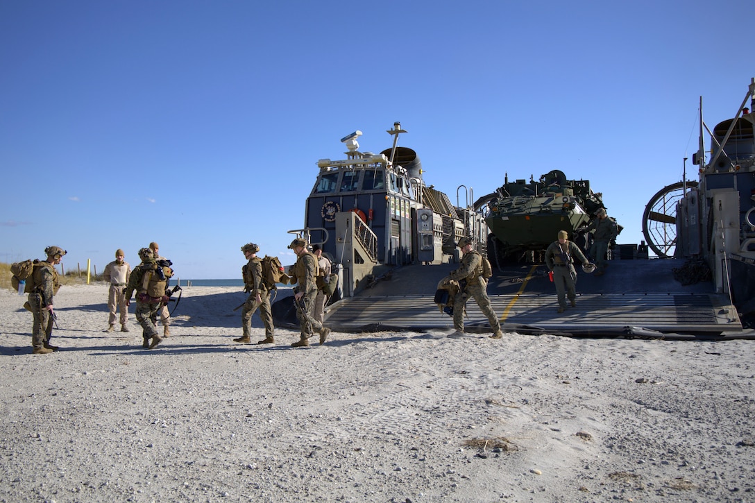 U.S. Marines with the 24th Marine Expeditionary Unit (Special Operations Capable) walk across the beach after finally returning home, Onslow Beach, North Carolina, Dec. 2, 2024. The Marines with the 24th MEU (SOC) return to Camp Lejeune following a 7-month long deployment to U.S. Naval Forces Europe and Africa area of operation. Embarked on the Navy’s Wasp Amphibious Ready Group, the 24th MEU (SOC) supported U.S. Allied, and partner interests in the region, including the Eastern Mediterranean Sea, to promote regional stability and deter aggression. (U.S. Marine Corps photo by Sgt. Michele Clarke)